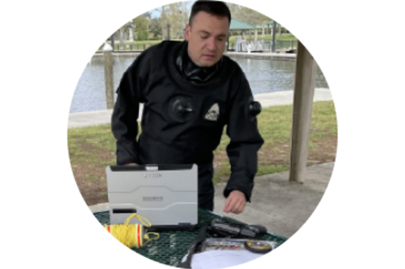 Police officer with TOUGHBOOK in a park