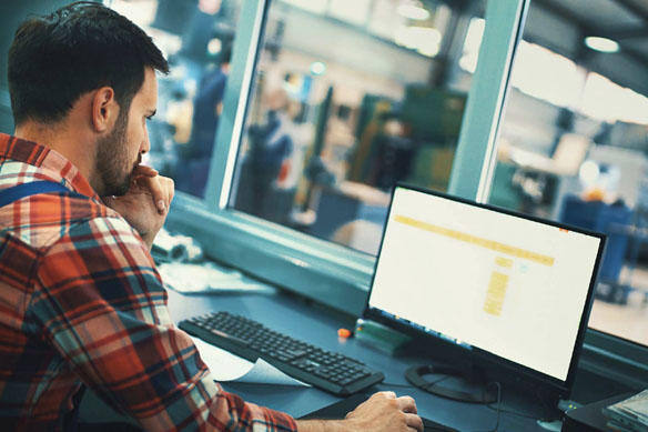 Man sitting a desk working on computer