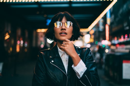 Woman with glasses looking at light display