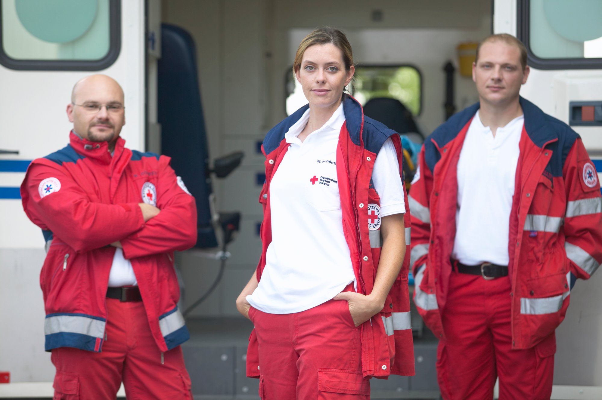 ems first responders in red cross vests