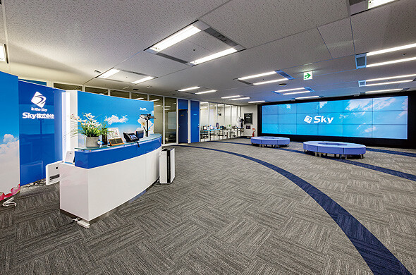 SkyCo lobby area with branding on displays