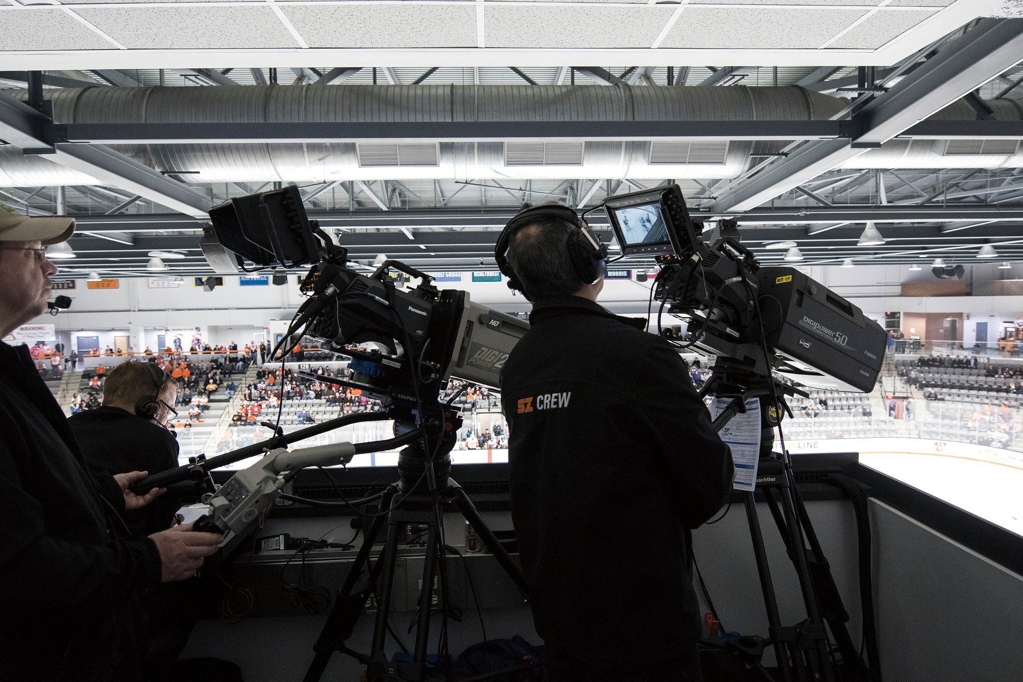 Sports broadcast camera crew filming in a stadium