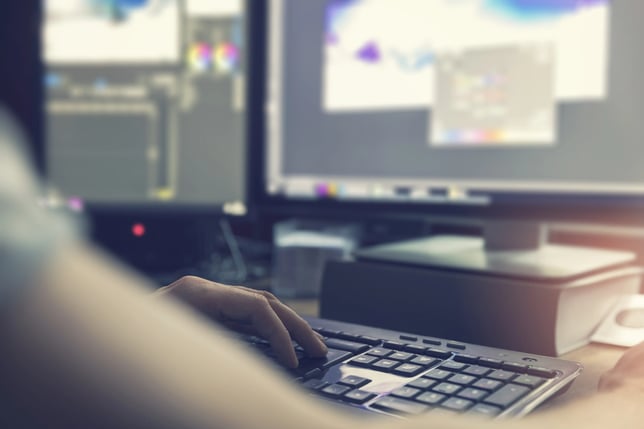 A person at their computer uses KAIROS digital AV solutions to edit a house of worship broadcast.