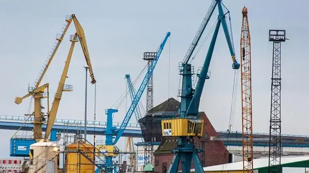 Construction cranes at an industrial jobsite where real-time construction data helps teams improve project visibility and decision-making.