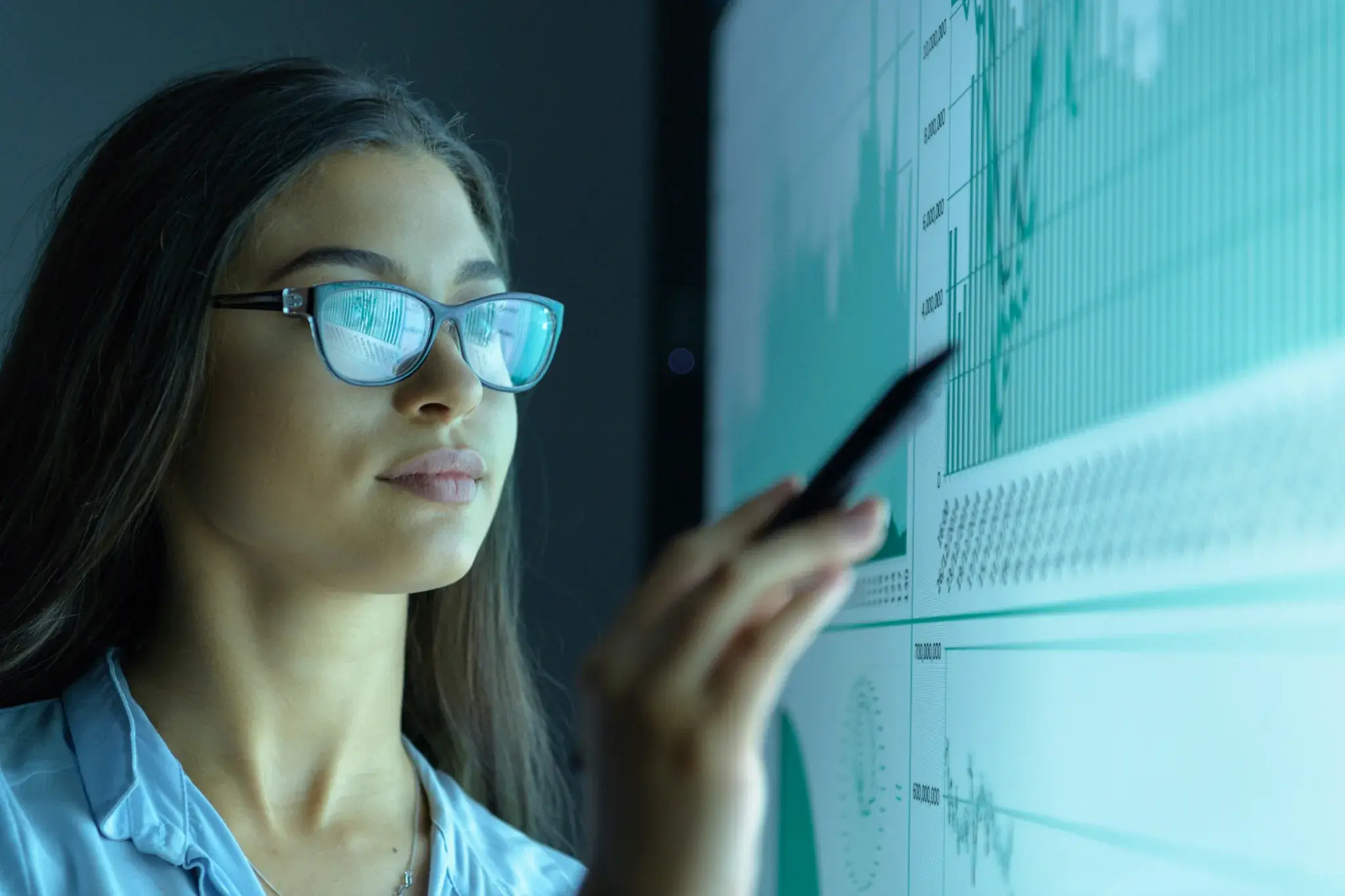 Person using touchscreen display to analyze data charts and graphs