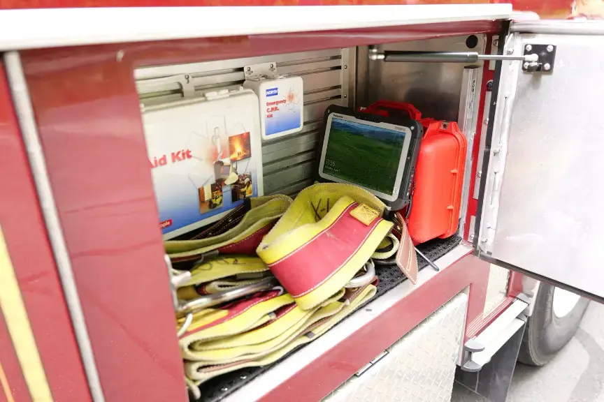 Team of Professional Firefighters Working on Wildland Fire Location, Extinguishing the Fire. Brave Female Firefighter in Safety Suit and Helmet Using a Fire Hose in Tandem with a Colleague.