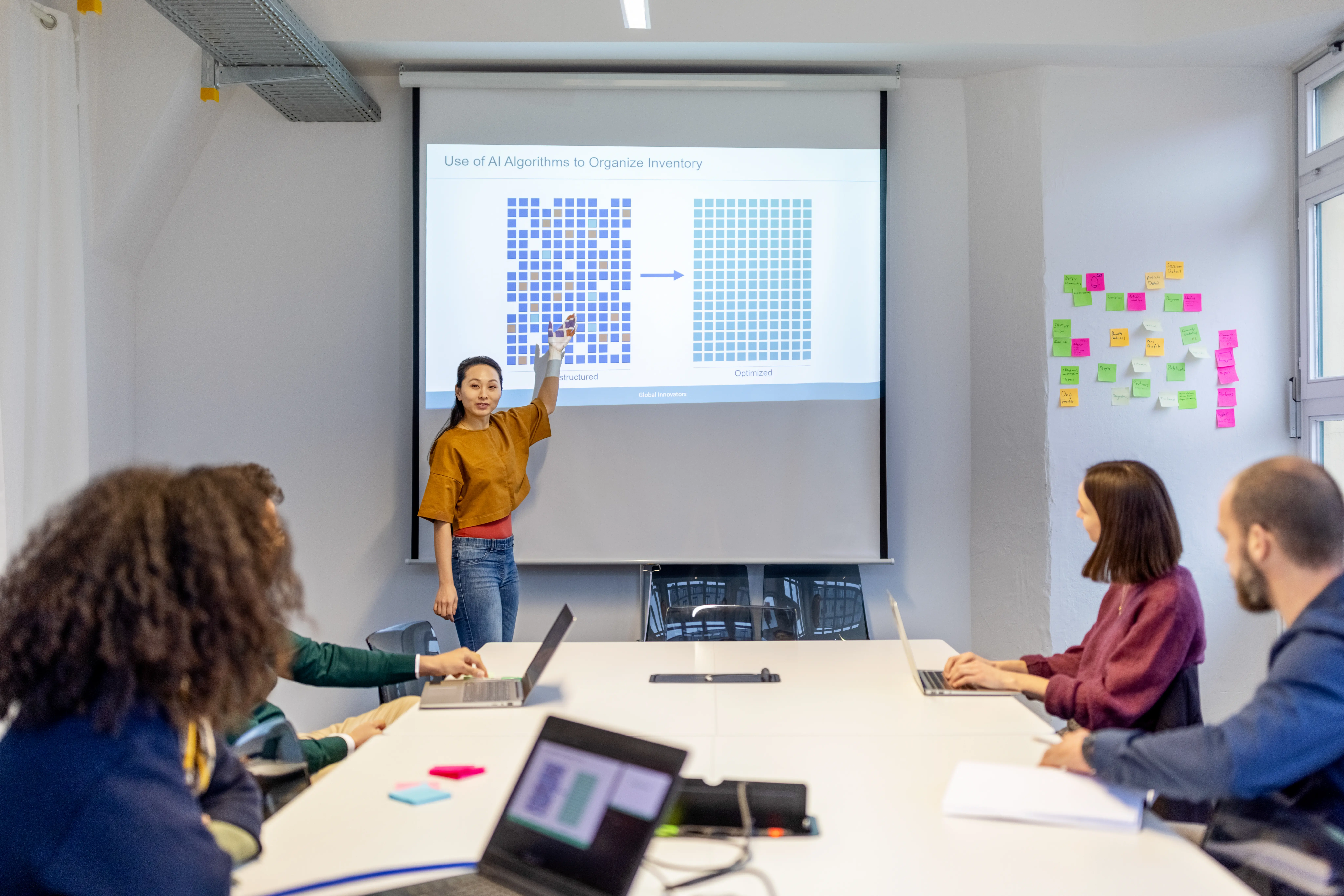 Businesswoman  giving a presentation to the team in tech startup office boardroom
