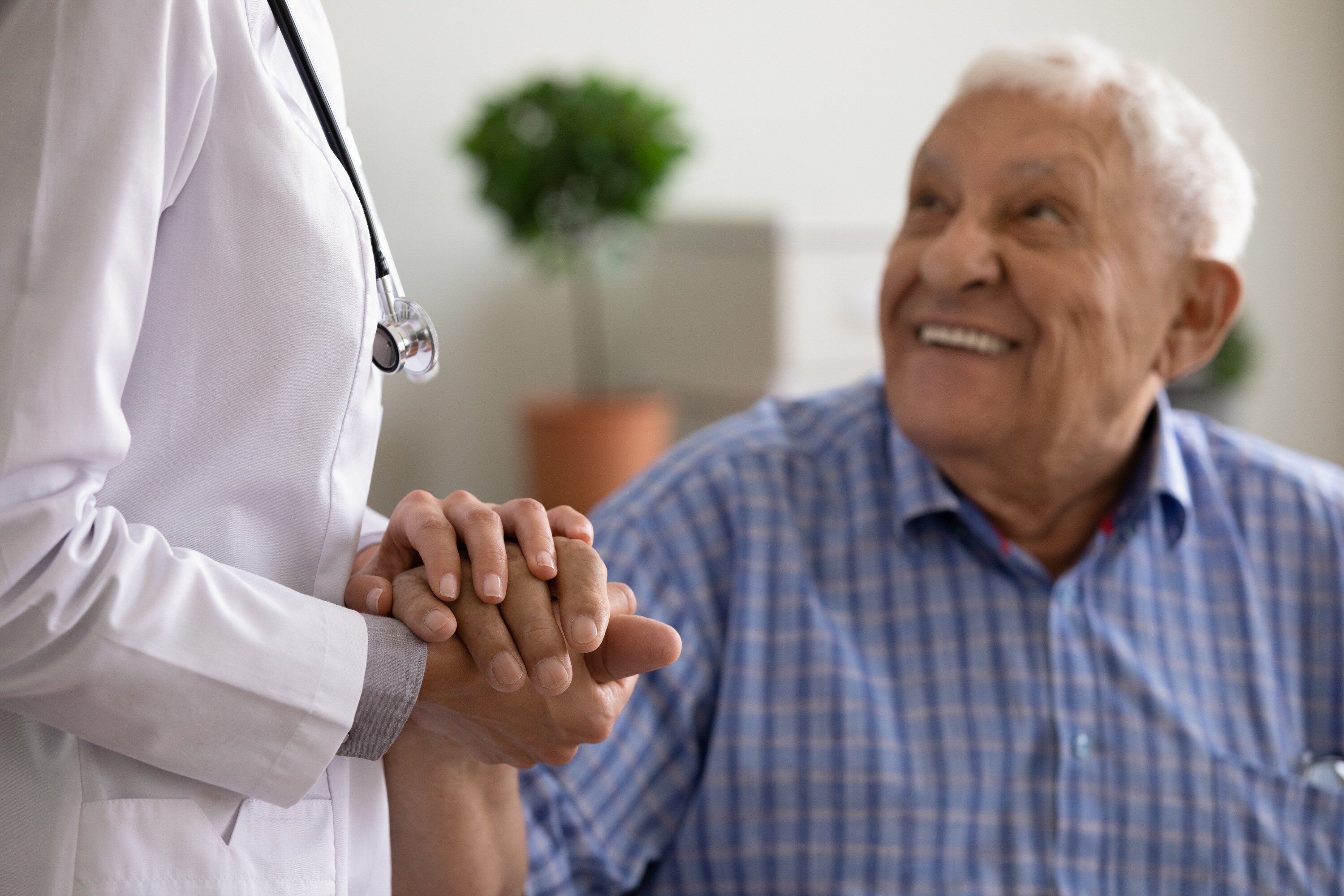 Female nurse comfort support old male patient