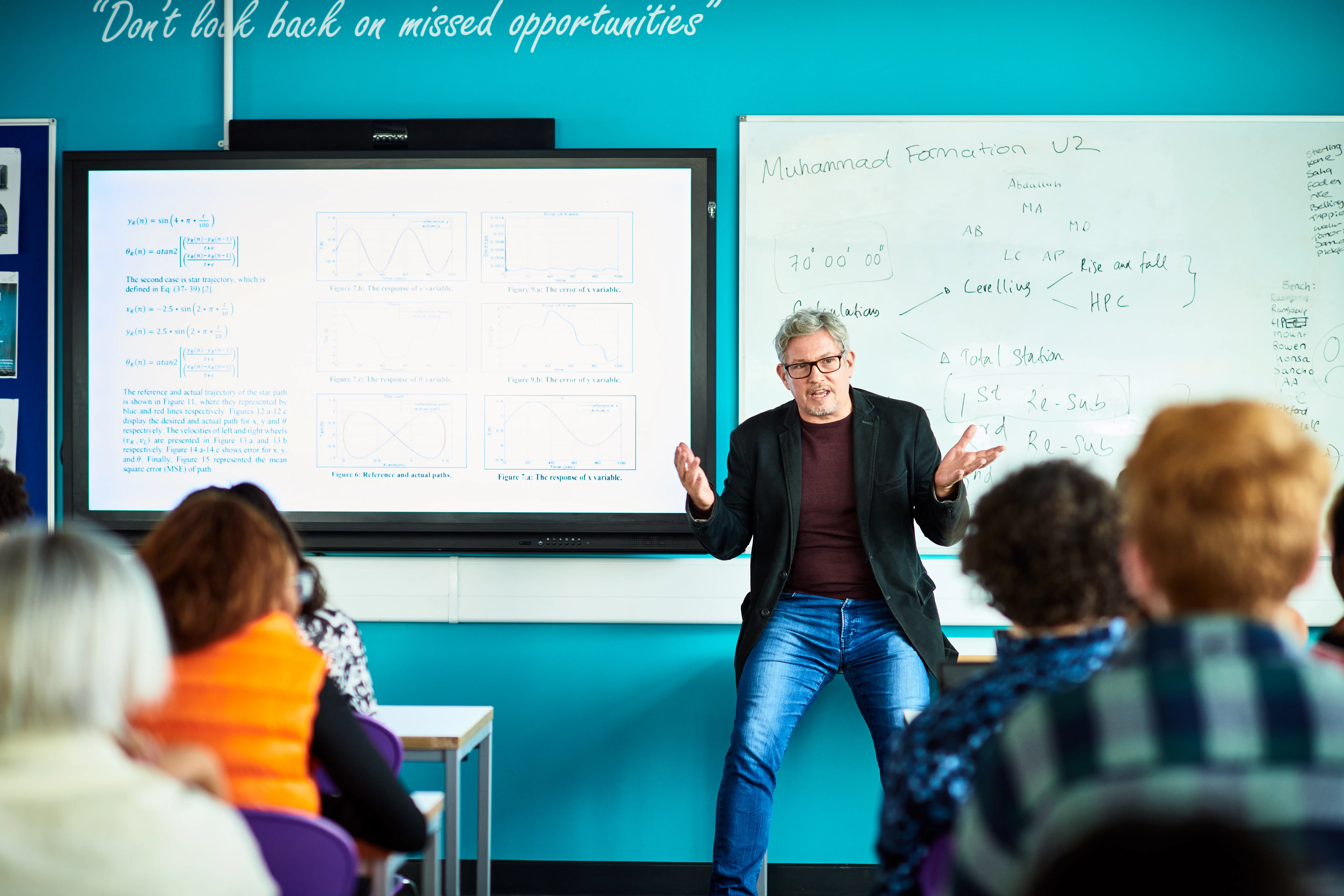 Male college lecturer teaching technical college class