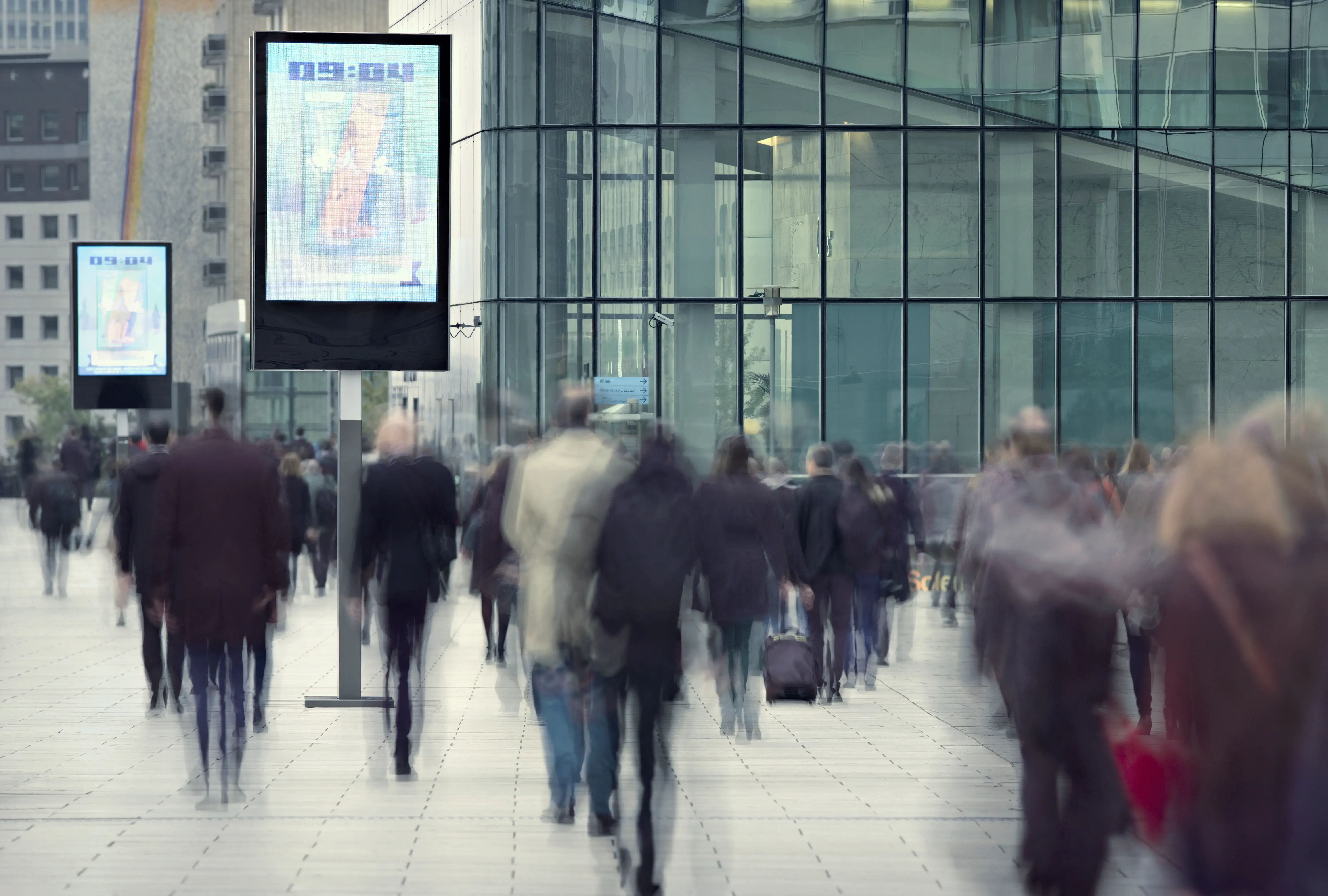 Motion blurred people walking to work at La Defense business district of Paris