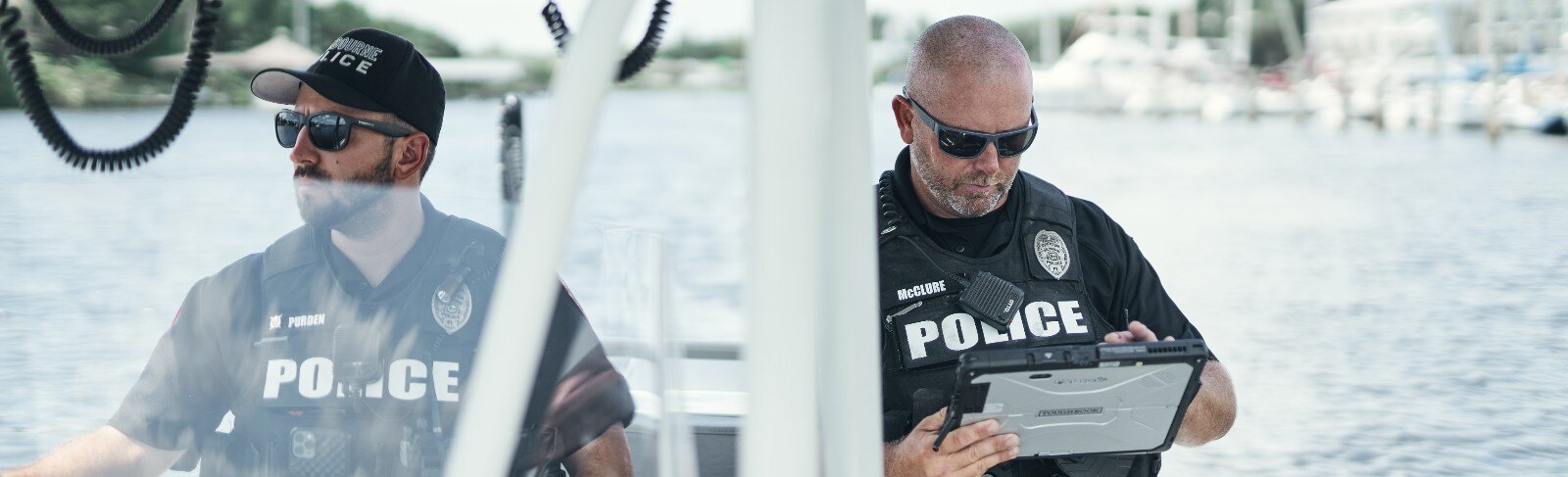 police officers using a tablet on a boat.jpg