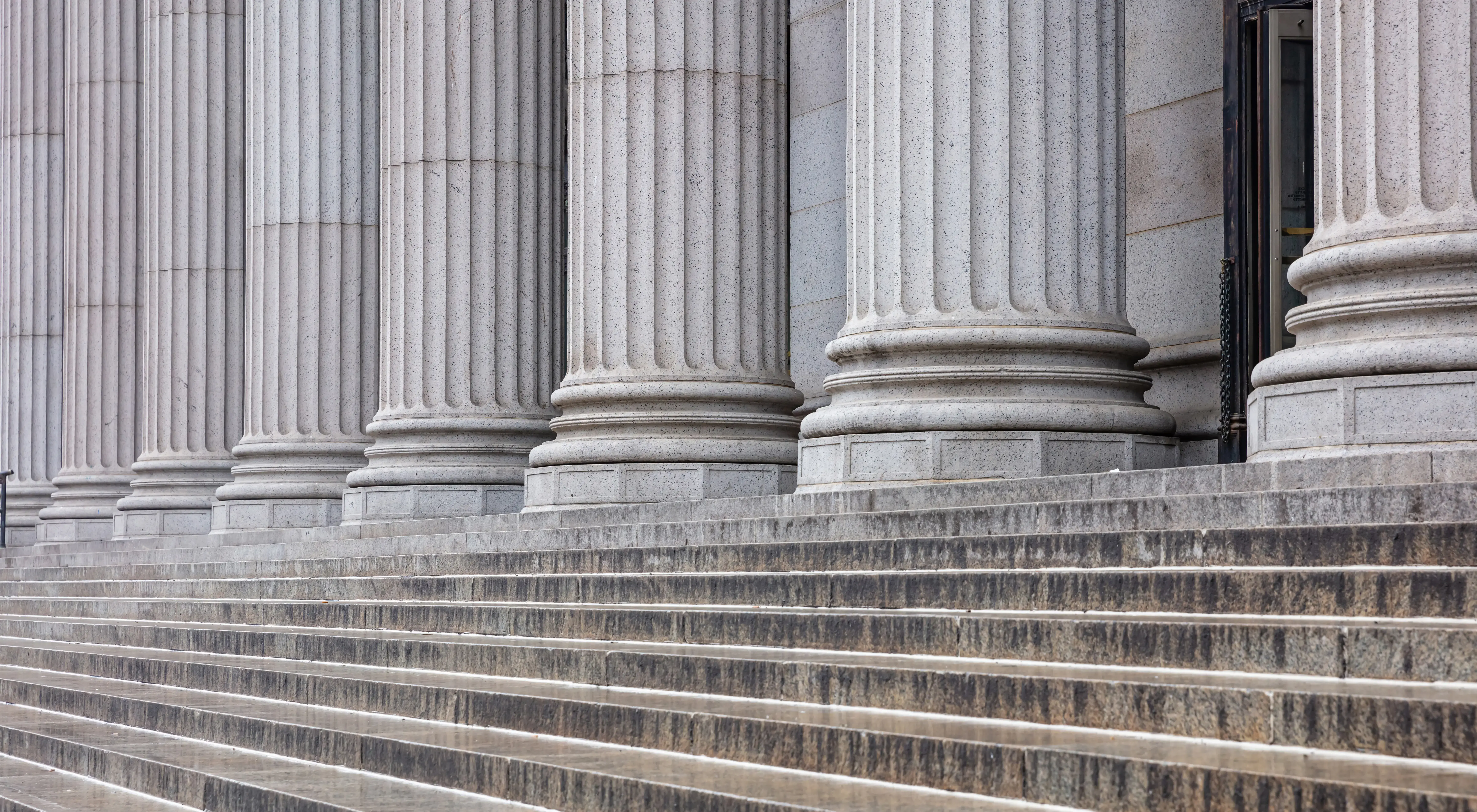 Stone pillars row and stairs detail. Classical building facade