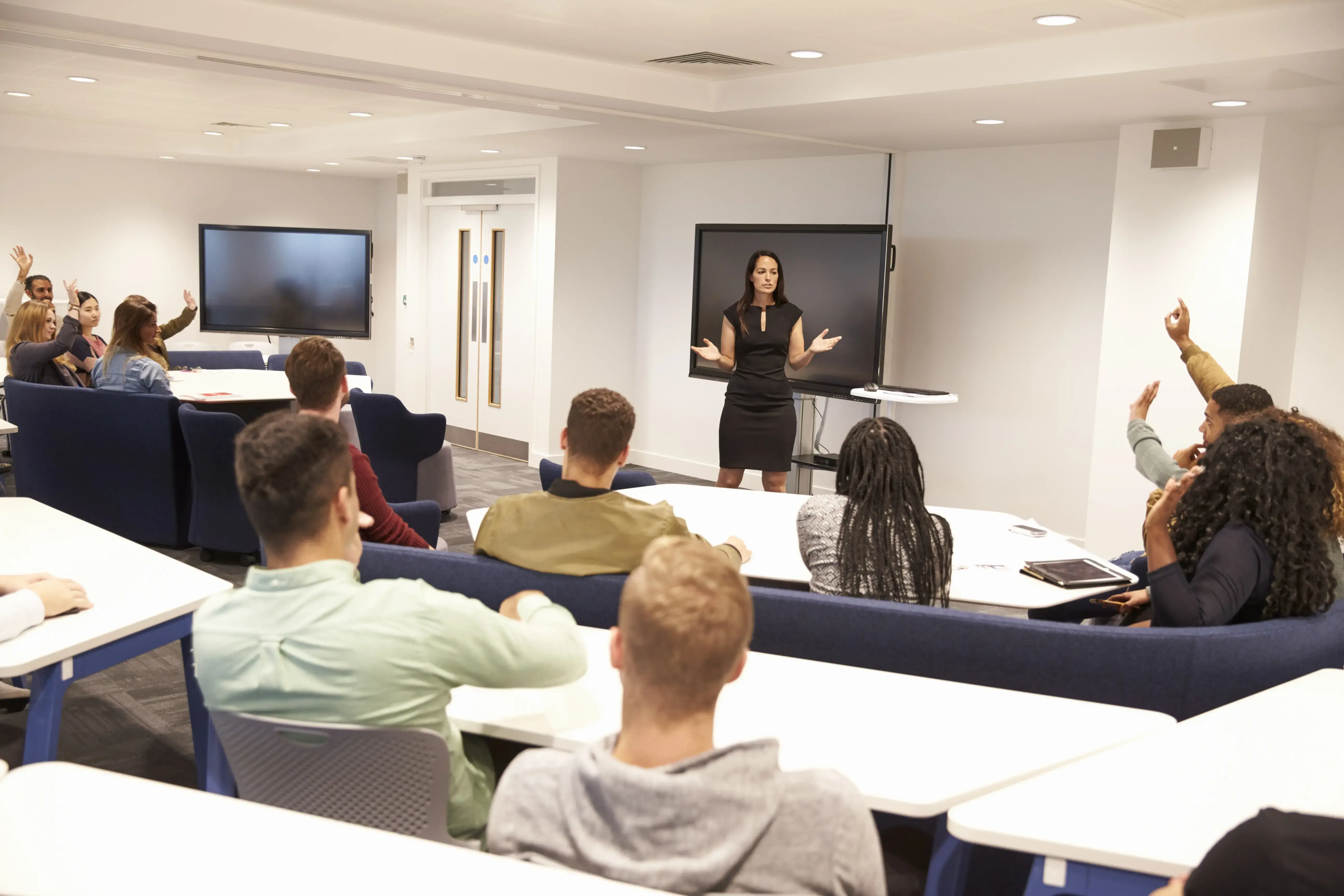 University students study in classroom with female lecturer