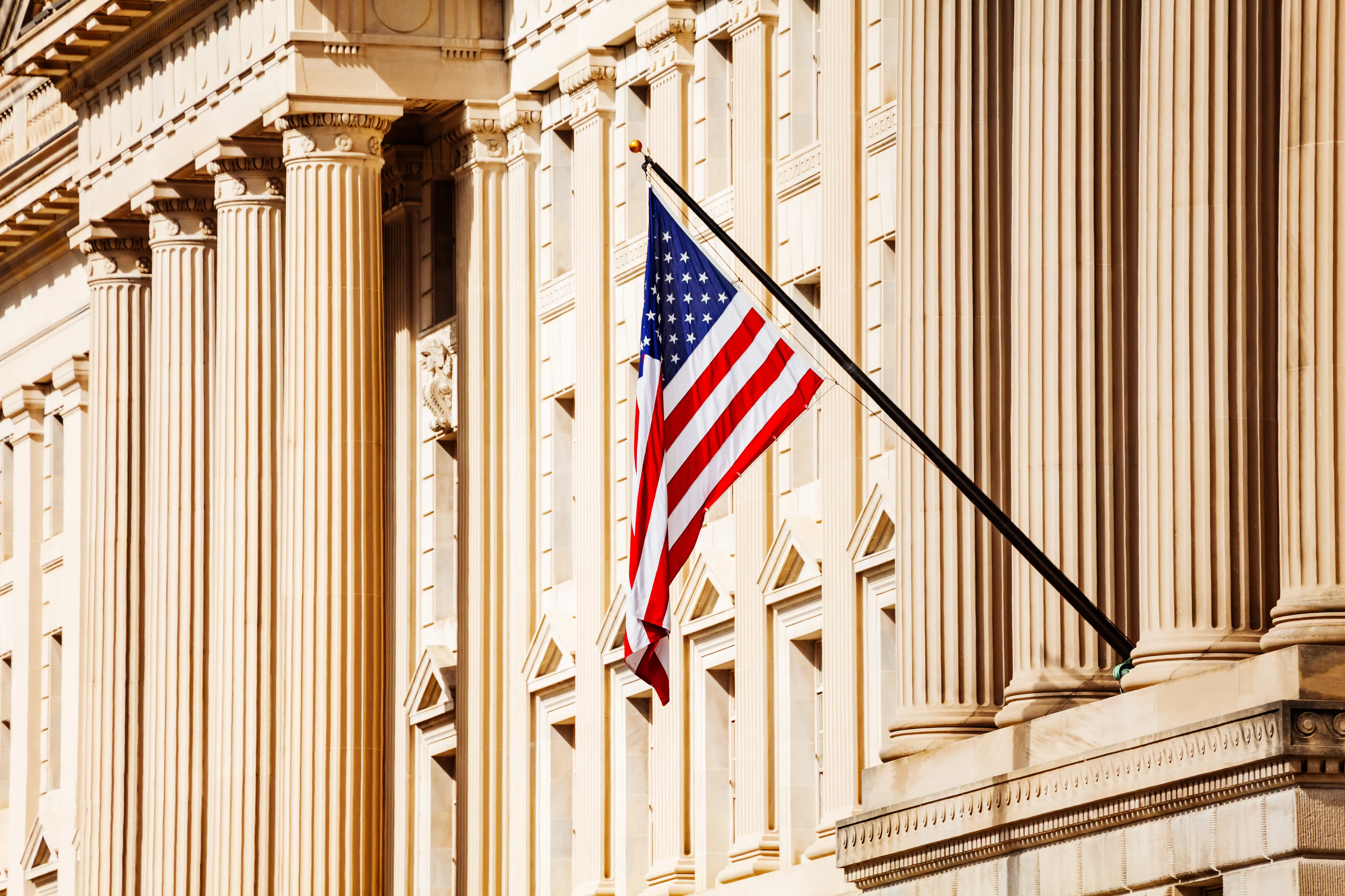 US flag over government building in Washington, DC